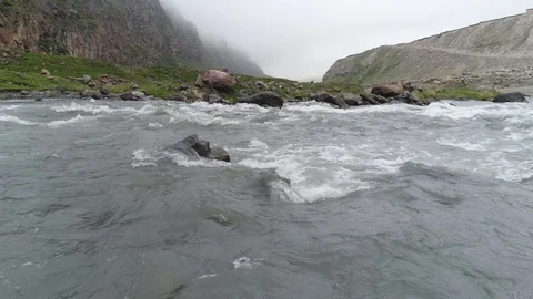 Drone flight very low over water of stormy mountain river. Aerial view. Stock-Footage 91016271