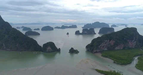 Drone flight video under many rocky islands in a calm Phang Nga bay at sunrise Video stock 76283990