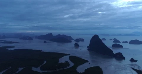 Drone flight video under many rocky islands in a calm Phang Nga bay at sunrise Video stock 76284013
