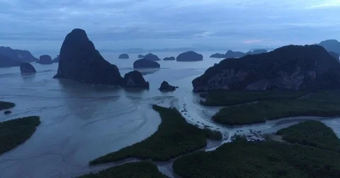 Drone flight video under many rocky islands in a calm Phang Nga bay at sunrise Stock Footage 76284106