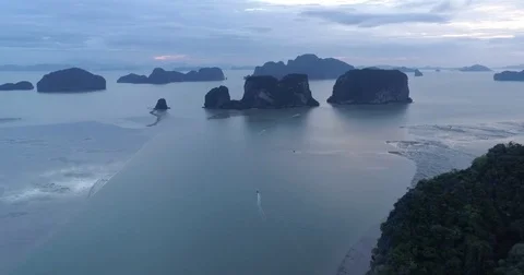 Drone flight video under many rocky islands in a calm Phang Nga bay at sunrise Video stock 76284305