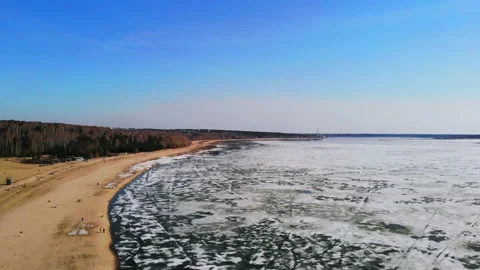 Drone flight with a view of the sandy beach and the sea in the melting ice. Stock Footage 133763034