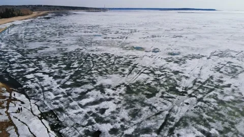 Drone flight with a view of the sandy beach and the sea in the melting ice. Stock Footage 133763123