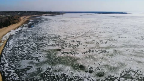 Drone flight with a view of the sandy beach and the sea in the melting ice. Stock Footage 133763180