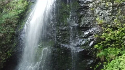 Drone flight of a waterfall in the mountains 4k Stockbeeldmateriaal 137921156
