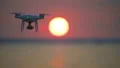The drone flighting on the bright sunset background 4k or 4k+ Resolution