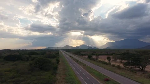 Drone floating over road then ascending to reveal dramatic sunset on Ruta del 스톡 동영상 331025219