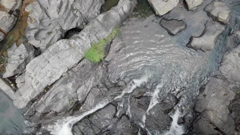 Drone Floating Shot Over Small River Flowing Through Rocks in Tropical Fores Stock Footage 314550568