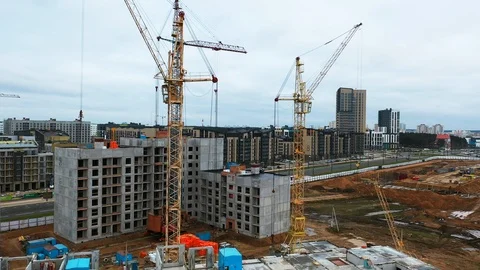 Drone fly above construction crane, development process of high rise block of Stock Footage 119951111