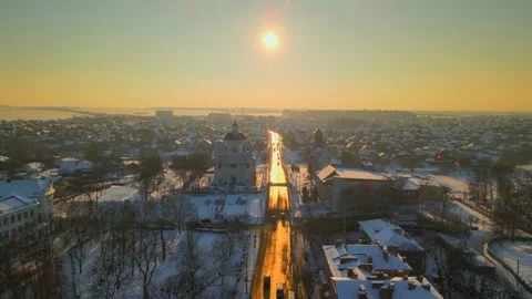 Drone fly above road at snow covered small European city in winter sunset, HDR Stock Footage 150893755
