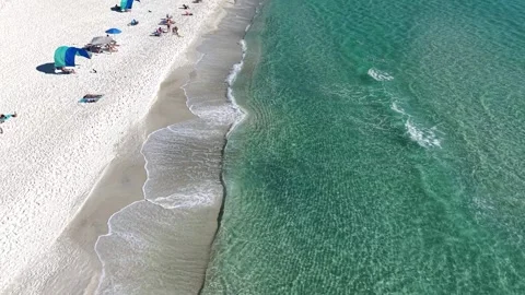 Drone fly along Santa Rosa Beach with crystal clear Gulf water and beach goers Stock Footage 322585841