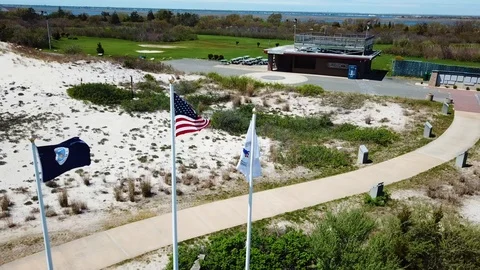 Drone fly around 9-11 Memorial Cedar Beach American Flag Stock Footage 107677337