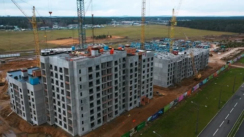 Drone fly around construction crane, development process of high rise block of Stock Footage 119829955