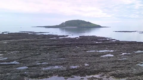 Drone fly forward towards Looe Island from Hannafore Beach Cornwall UK calm sea Stock Footage 331429069