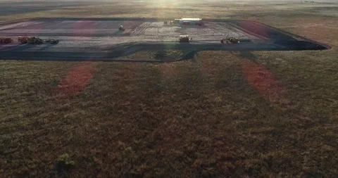 Drone fly up to a mostly empty fracking pad during sunset. Drone 4k 60fps Stock Footage 167931339