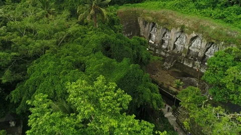 Drone Fly-Out over tropical forest of Ancient Temple in Bali, Indonesia Stock Footage 104994545