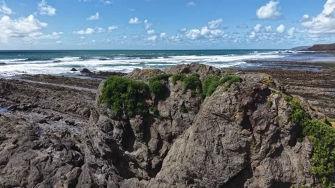 Drone fly over Black Rock on Widemouth Bay beach Stock Footage 336561361