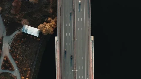 Drone fly over bridge with river, many cars moving on multi-lane road Video stock 144276602