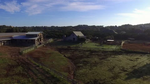 Drone Fly Over Central Texas Horse Stable with Jockey Walking to Barn at Sunr Stock Footage 68068792