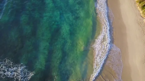 Drone fly over an empty tropical beach with white sand and turquoise water Video stock 78075638