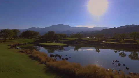 Drone fly over Golf course lake and beautiful mountains Stock Footage 167143022