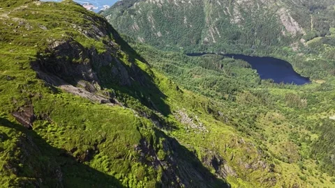Drone fly over grassy cliff Ulriken mountain in Bergen, Norway. July 2026 Stock Footage 340080309