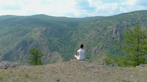 Drone Fly over impressive mountains with girl on a cliff face, vertigo effect Stock Footage 92058284