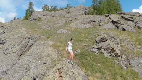Drone Fly over impressive mountains with walking girl on a cliff Vídeo Stock 92065948