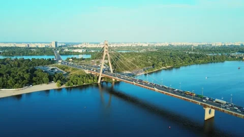 Drone fly over the North Bridge over the Dnipro River and road traffic at Sunset Video stock 200974415