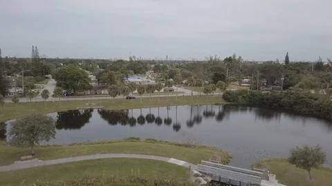 Drone Fly over Park With Lake to Community Stock Footage 104482724