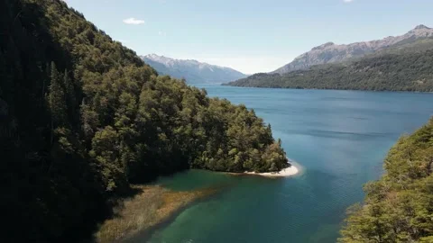 Drone fly over a patagonic emerald beautiful river towards a lake. Stock Footage 147298596
