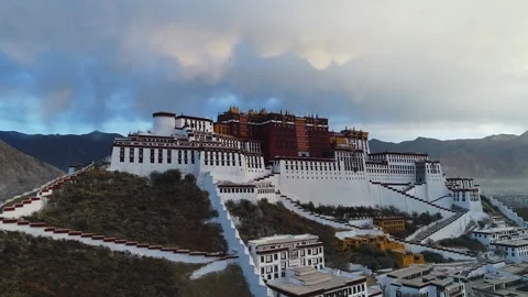 Drone Fly-Over of Potala Palace at Sunrise Revealing Lhasa, Tibet China Stock Footage 336936616