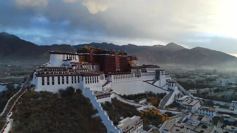 Drone Fly-Over of Potala Palace at Sunrise Revealing Lhasa, Tibet China Stock Footage 336937166