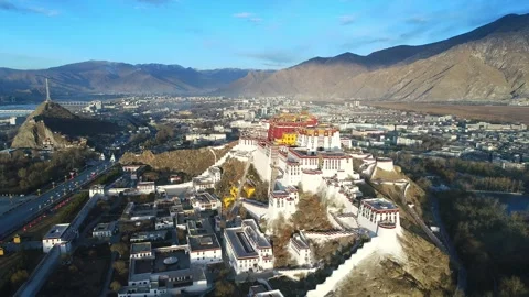 Drone Fly-Over of Potala Palace at Sunrise Revealing Lhasa, Tibet China Stock Footage 337014502