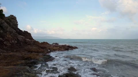 A drone fly over rocks and the seashore, capturing waves of Koh Samui Island Stock Footage 264502259
