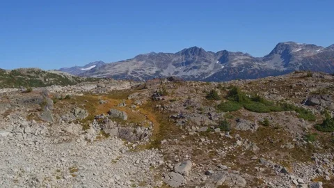 Drone Fly Over Rocky Alpine Terrain with Mountains in Background Stock Footage 82634797