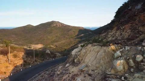 Drone fly over scenic mountain road with rocky cliffs and picturesque landscape. Stock Footage 140944816