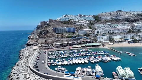 Drone Fly-In Over Small Boat Harbor and Tourist Area, Turquoise Water Stock Footage 310142617