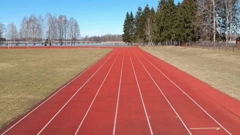 Drone fly over spring stadium red running tracks, aerial Stock Footage 93599196