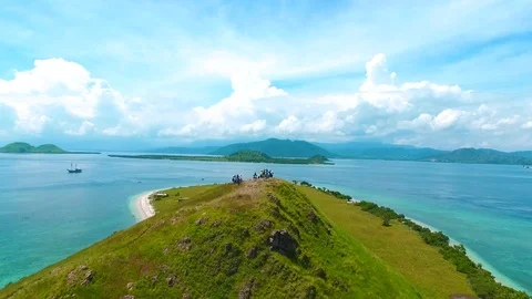 Drone fly over on top of hill kenawa, with clear blue sky in Kenawa Island Video stock 114399483