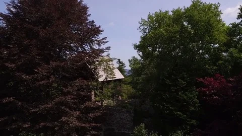 Drone fly over trees to reveal Maine coastand sail boat. Stock Footage 84708187