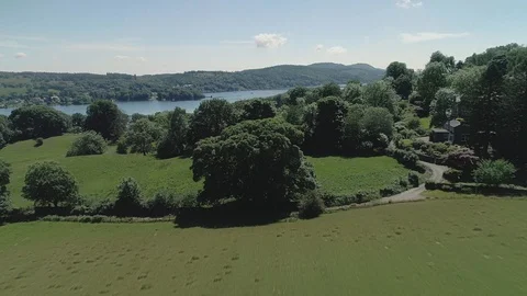 Drone Fly Over Trees toward lake Lake District Video stock 102953866