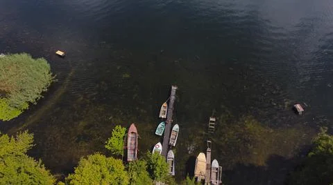 Drone fly over waving river of blue color surrounded by local village with va Stock Photos