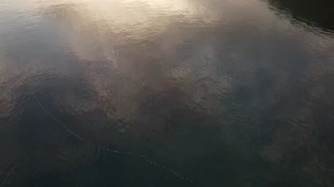 Drone fly reflections of clouds at sea suface and sunset Stock Footage 144920838