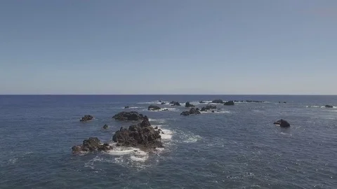 Drone fly by shot of rocks off coast Stock Footage 82849398