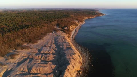 Drone fly slowly backwards over rocky shores of Danish island Bornholm Stock Footage 314213285