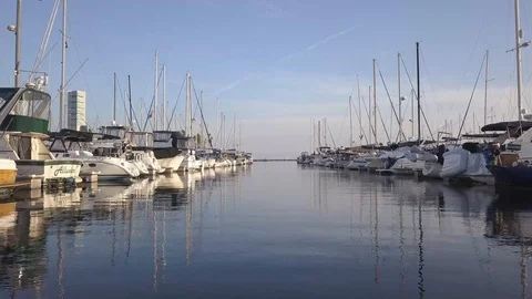 Drone fly through boats at a dock in a marina at sunset Stock Footage 96718436