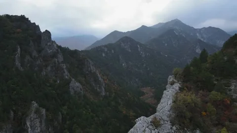 Drone fly through mountain cliff in Greece with overcast 4K 60FPS Stock Footage 236611671