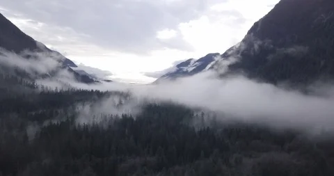 Drone fly through mountain valley with fog Stock Footage