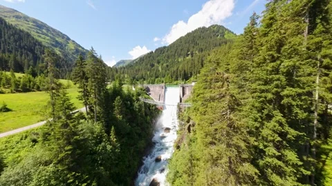 Drone fly through river ending up on a waterfall dam of  verwallsee in Austria Stock Footage 279664346